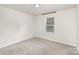 Bright carpeted bedroom with a window and minimal decor at 205 Athens Dr # 31, Salisbury, NC 28147