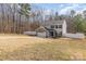 Two-story home with brick garage, gray siding, black shutters, surrounded by a fenced yard and green trees at 205 Athens Dr # 31, Salisbury, NC 28147