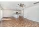 Open-concept living room with hardwood floors, a ceiling fan, and a view of the modern kitchen at 205 Athens Dr # 31, Salisbury, NC 28147