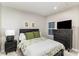Cozy bedroom with green accents, showcasing comfortable bedding and side table with lamp at 2061 Dornoch Rd, Fort Mill, SC 29708