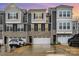 Beautiful townhome exterior boasts stone accents, gray siding and a two-car garage at 2061 Dornoch Rd, Fort Mill, SC 29708