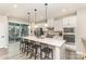 Bright, modern kitchen with stainless steel appliances, quartz countertops, and a large center island with seating at 2061 Dornoch Rd, Fort Mill, SC 29708