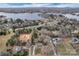 Aerial view highlighting a neighborhood with homes, a lake in the background, and a house under construction at 2201 Holly Ln, Shelby, NC 28150