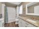 Bright bathroom with white subway tile, granite countertop, and wood-look floors at 2201 Holly Ln, Shelby, NC 28150