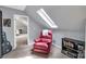 Bright bedroom with a skylight and a comfy red armchair at 2201 Holly Ln, Shelby, NC 28150