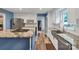 Modern kitchen featuring white cabinets, stainless steel appliances, and a granite island at 2201 Holly Ln, Shelby, NC 28150