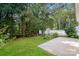 Green backyard with patio and white picket fence overlooking the wooded area at 221 Chicago Ln, York, SC 29745