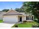 Charming single-story home with well-maintained lawn, attached garage, and inviting front entrance at 221 Chicago Ln, York, SC 29745