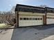 Garage with paneled door; the exterior features brick accents and a well-maintained setting at 227 Perrin Pl, Charlotte, NC 28207