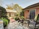 Private patio featuring slate flooring, comfortable outdoor seating, and lush landscaping creating a serene retreat at 227 Perrin Pl, Charlotte, NC 28207