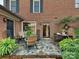 Inviting brick patio with stylish slate flooring and comfortable seating surrounded by lush greenery at 227 Perrin Pl, Charlotte, NC 28207