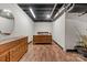 Basement bedroom includes wood-look floors, a dresser, and an exposed ceiling at 24253 Old Aquadale Rd, Albemarle, NC 28001