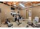 Finished basement exercise area with workout machines, television and mirrored walls at 24253 Old Aquadale Rd, Albemarle, NC 28001
