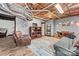 Finished basement with a seating area, shelving, and a decorative rug on wood floors at 24253 Old Aquadale Rd, Albemarle, NC 28001
