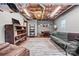 Finished basement featuring a sitting area, shelving, and natural wood floors at 24253 Old Aquadale Rd, Albemarle, NC 28001