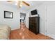 Well-lit bedroom featuring hardwood floors, a large dresser, and ample closet space at 24253 Old Aquadale Rd, Albemarle, NC 28001