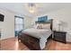 Comfortable bedroom featuring a wooden bed frame, ceiling fan, and natural light at 24253 Old Aquadale Rd, Albemarle, NC 28001