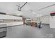 Large garage with multiple garage doors, bright lighting, dining, and ample storage at 24253 Old Aquadale Rd, Albemarle, NC 28001