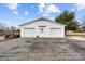 Detached two-car garage with white siding and doors, set on a spacious driveway, enhancing the property's appeal at 24253 Old Aquadale Rd, Albemarle, NC 28001