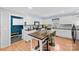 Modern kitchen with stainless steel appliances, white cabinets, and eat-in dining area at 24253 Old Aquadale Rd, Albemarle, NC 28001