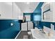 Functional laundry room with a sink, washer, dryer and storage cabinets at 24253 Old Aquadale Rd, Albemarle, NC 28001