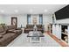 Cozy living room featuring hardwood floors, stylish sofas, and an entertainment center at 24253 Old Aquadale Rd, Albemarle, NC 28001