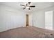 Bedroom features a ceiling fan, closet, and adjoining bathroom access at 259 Unionville Indian Trail W Rd, Indian Trail, NC 28079