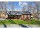 Charming brick home featuring a covered porch and swing, complemented by a well-manicured lawn at 259 Unionville Indian Trail W Rd, Indian Trail, NC 28079