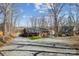 Charming brick home with a covered porch, surrounded by mature trees and spacious gravel driveway at 259 Unionville Indian Trail W Rd, Indian Trail, NC 28079