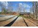 Cozy home featuring a covered porch and a spacious gravel driveway surrounded by mature trees at 259 Unionville Indian Trail W Rd, Indian Trail, NC 28079