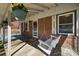 Charming front porch with a hanging swing and flower baskets creating a welcoming entrance at 259 Unionville Indian Trail W Rd, Indian Trail, NC 28079