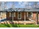 Inviting front porch with hanging flower baskets and a cozy swing, perfect for relaxing at 259 Unionville Indian Trail W Rd, Indian Trail, NC 28079