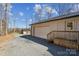Spacious garage with wooden steps and plenty of parking space in the gravel driveway at 259 Unionville Indian Trail W Rd, Indian Trail, NC 28079
