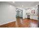 Stylish kitchen showcasing stainless steel appliances, white cabinets, and hardwood floors, open to living area at 259 Unionville Indian Trail W Rd, Indian Trail, NC 28079