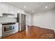 Modern kitchen featuring stainless steel appliances, white cabinets, and hardwood floors with recessed lighting at 259 Unionville Indian Trail W Rd, Indian Trail, NC 28079