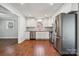 Well-lit kitchen featuring stainless steel appliances, white cabinetry, and hardwood floors, open concept design at 259 Unionville Indian Trail W Rd, Indian Trail, NC 28079