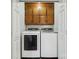 Convenient laundry room featuring modern washer and dryer units with storage, enclosed by white doors at 259 Unionville Indian Trail W Rd, Indian Trail, NC 28079