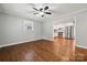 Spacious living room featuring hardwood floors and neutral paint, transitioning into a modern kitchen at 259 Unionville Indian Trail W Rd, Indian Trail, NC 28079