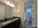 Modern bathroom featuring double sinks, dark cabinets, and a view of the toilet room at 283 Luray Way # 449, Rock Hill, SC 29730