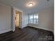 Well-lit bedroom with dark wood flooring and a bright window offering a pleasant view at 283 Luray Way # 449, Rock Hill, SC 29730