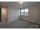 Bright bedroom with a large window, neutral walls, and plush carpeting at 283 Luray Way # 449, Rock Hill, SC 29730