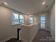 Bright hallway featuring windows and access to outdoor living, offering views of the neighborhood at 283 Luray Way # 449, Rock Hill, SC 29730