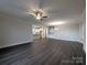 Spacious living room with dark wood floors, a ceiling fan, and an open layout to the kitchen at 283 Luray Way # 449, Rock Hill, SC 29730