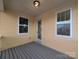 Covered patio with gray flooring and yellow siding offers a cozy outdoor living space at 283 Luray Way # 449, Rock Hill, SC 29730