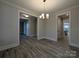 Open-concept dining room with modern light fixture, neutral walls, and wood-look flooring at 287 Luray Way # 450, Rock Hill, SC 29730