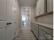 Hallway featuring gray cabinets, quartz countertops, and view of the kitchen area at 287 Luray Way # 450, Rock Hill, SC 29730