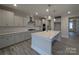 Modern kitchen with stainless steel appliances, gray cabinets, quartz countertops, and a spacious island at 287 Luray Way # 450, Rock Hill, SC 29730