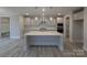 Kitchen featuring stainless steel appliances, gray cabinets, quartz countertops, and an island at 287 Luray Way # 450, Rock Hill, SC 29730