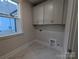 Bright laundry room featuring upper cabinets and luxury vinyl tile at 287 Luray Way # 450, Rock Hill, SC 29730