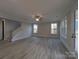 Bright living room with wood-look floors, neutral walls, staircase, and multiple windows at 287 Luray Way # 450, Rock Hill, SC 29730